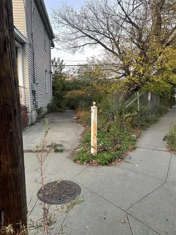 a pathway of a house with a yard