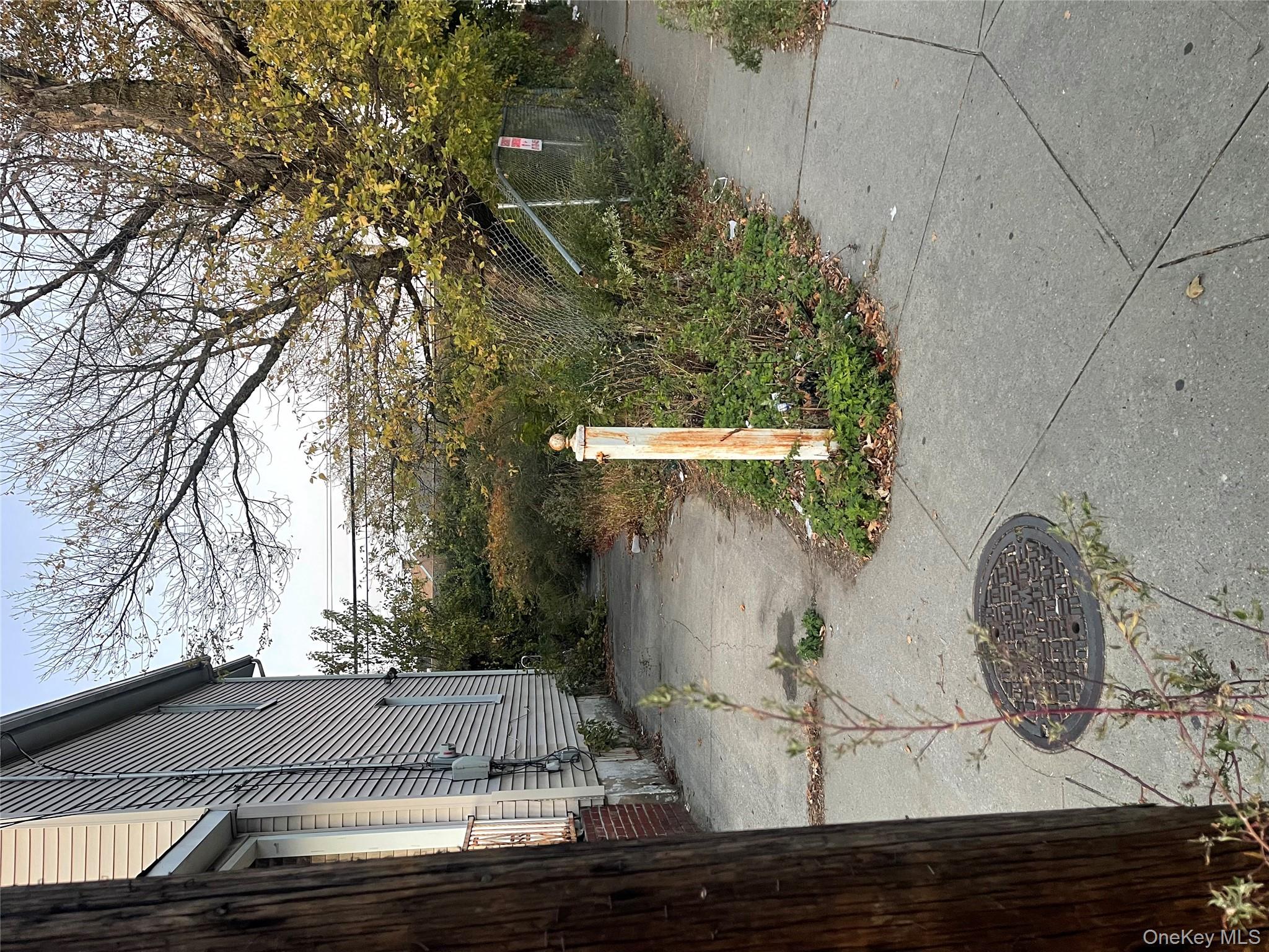 112-81 Bedell Street Queens, NY 11433 - Photo 2 of 2 a pathway of a house with a yard