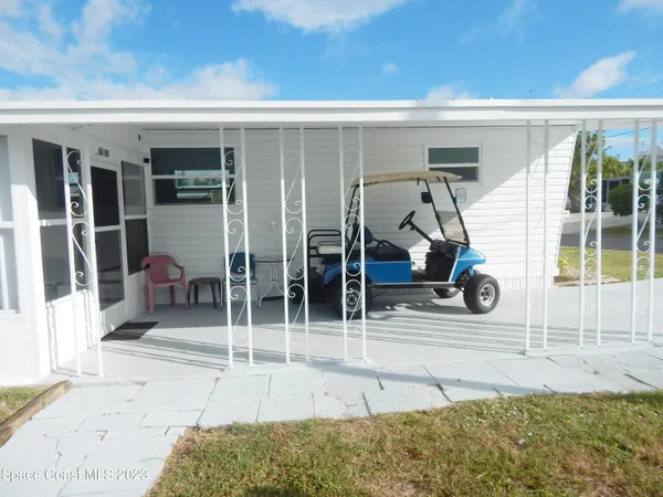 a kitchen with a refrigerator a table and chairs in it