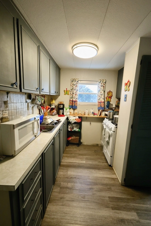 42 Better Way Springfield, MA 01119 - Photo 10 of 18 a kitchen with a sink stove and cabinets
