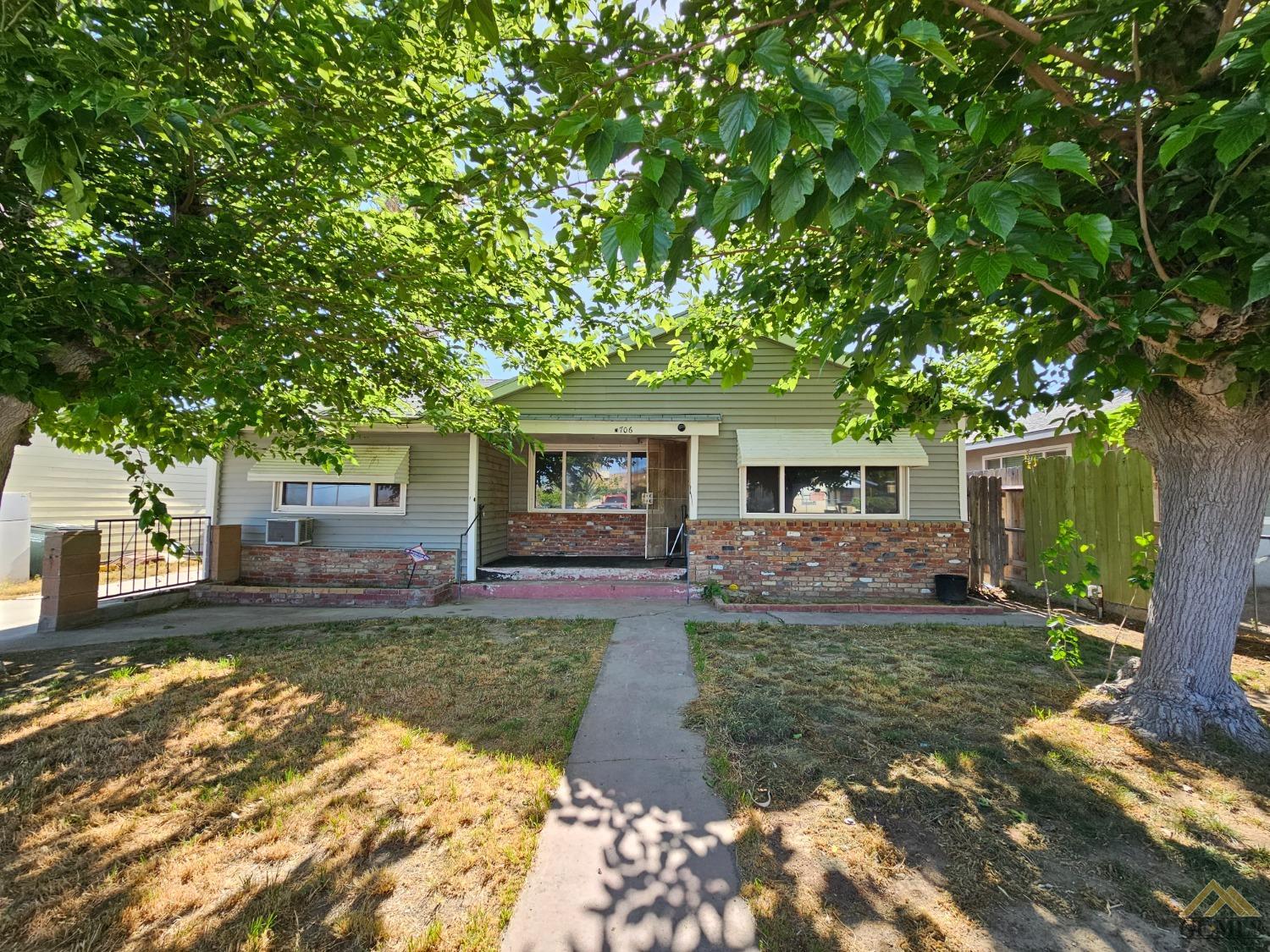 Undisclosed Address Taft, CA 93268 - Photo 1 of 20 a front view of a house with a yard