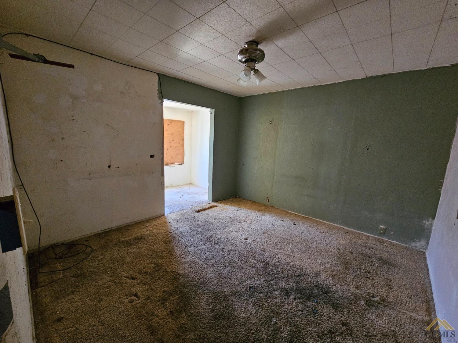 Undisclosed Address Taft, CA 93268 - Photo 14 of 20 an empty room with a empty space and windows