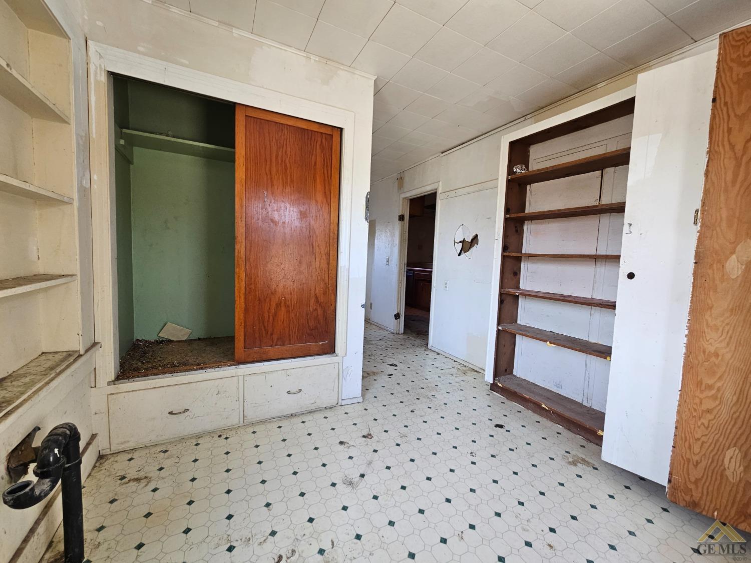 Undisclosed Address Taft, CA 93268 - Photo 16 of 20 a view of a closet area with an empty room