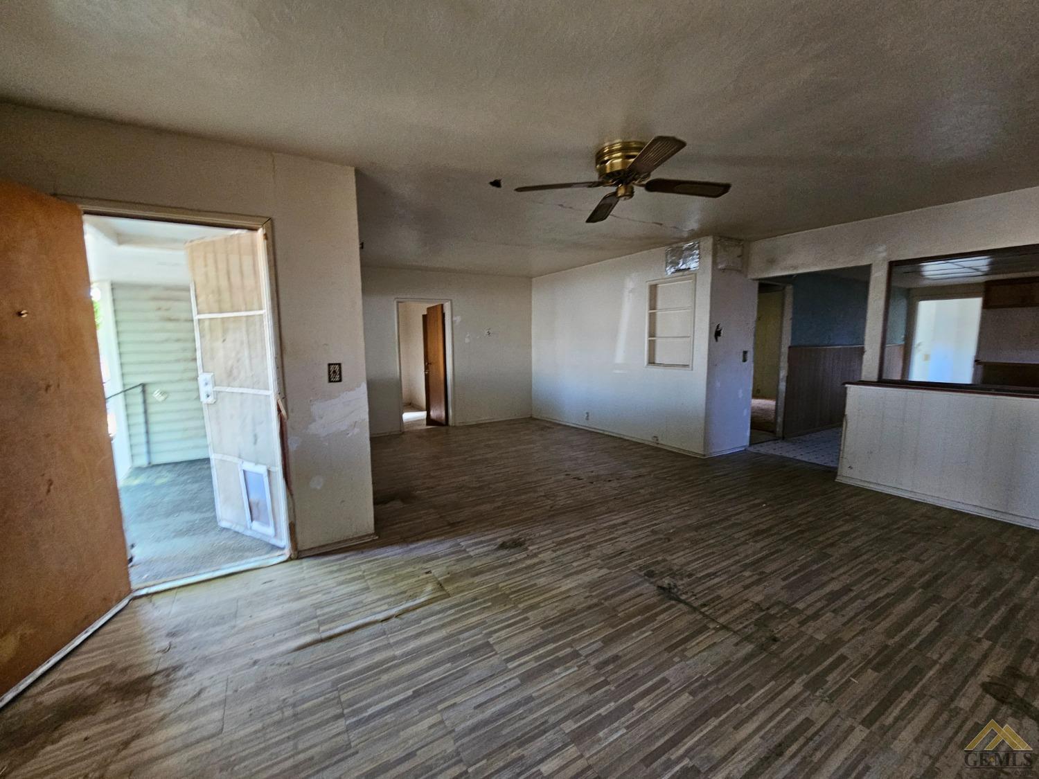 Undisclosed Address Taft, CA 93268 - Photo 5 of 20 an empty room with wooden floor and windows