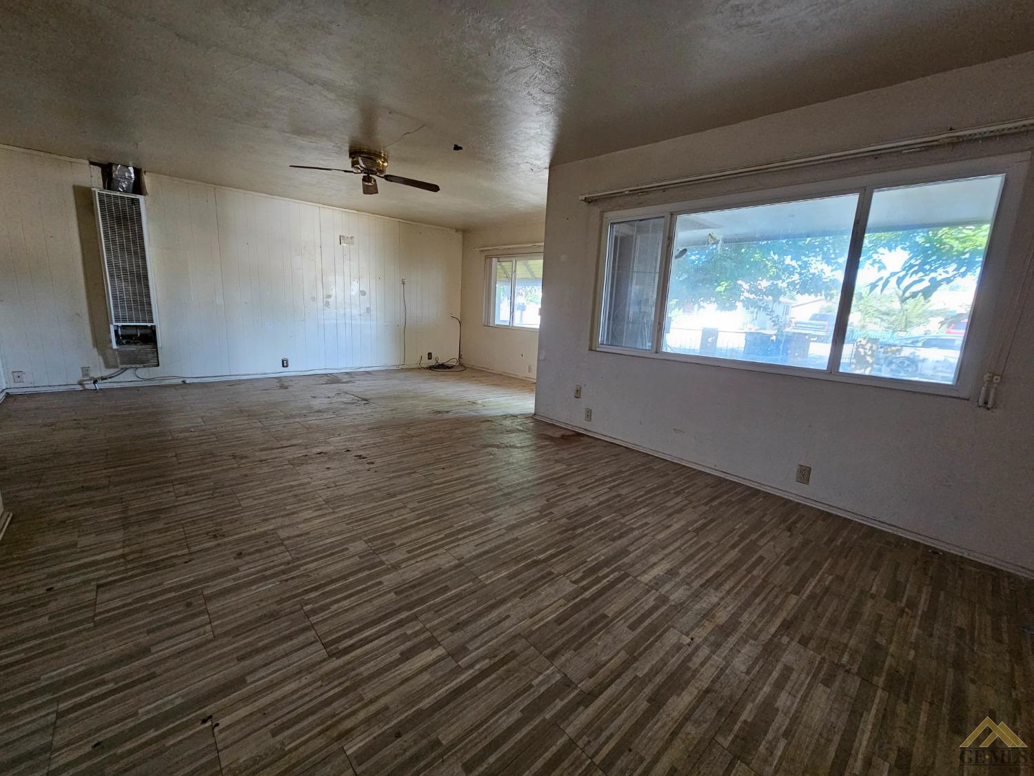 Undisclosed Address Taft, CA 93268 - Photo 9 of 20 an empty room with wooden floor and windows
