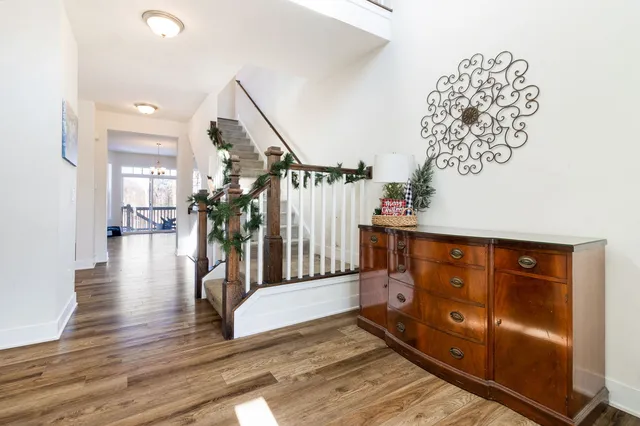 a view of entryway and hall with wooden floor