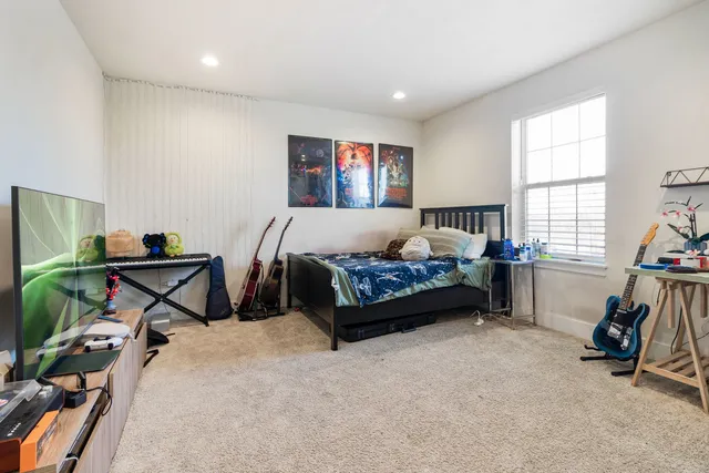 a spacious bedroom with a bed and a window