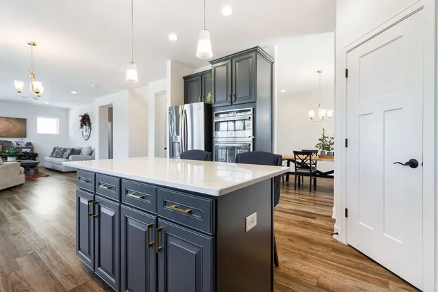 a kitchen with sink cabinets and wooden floor