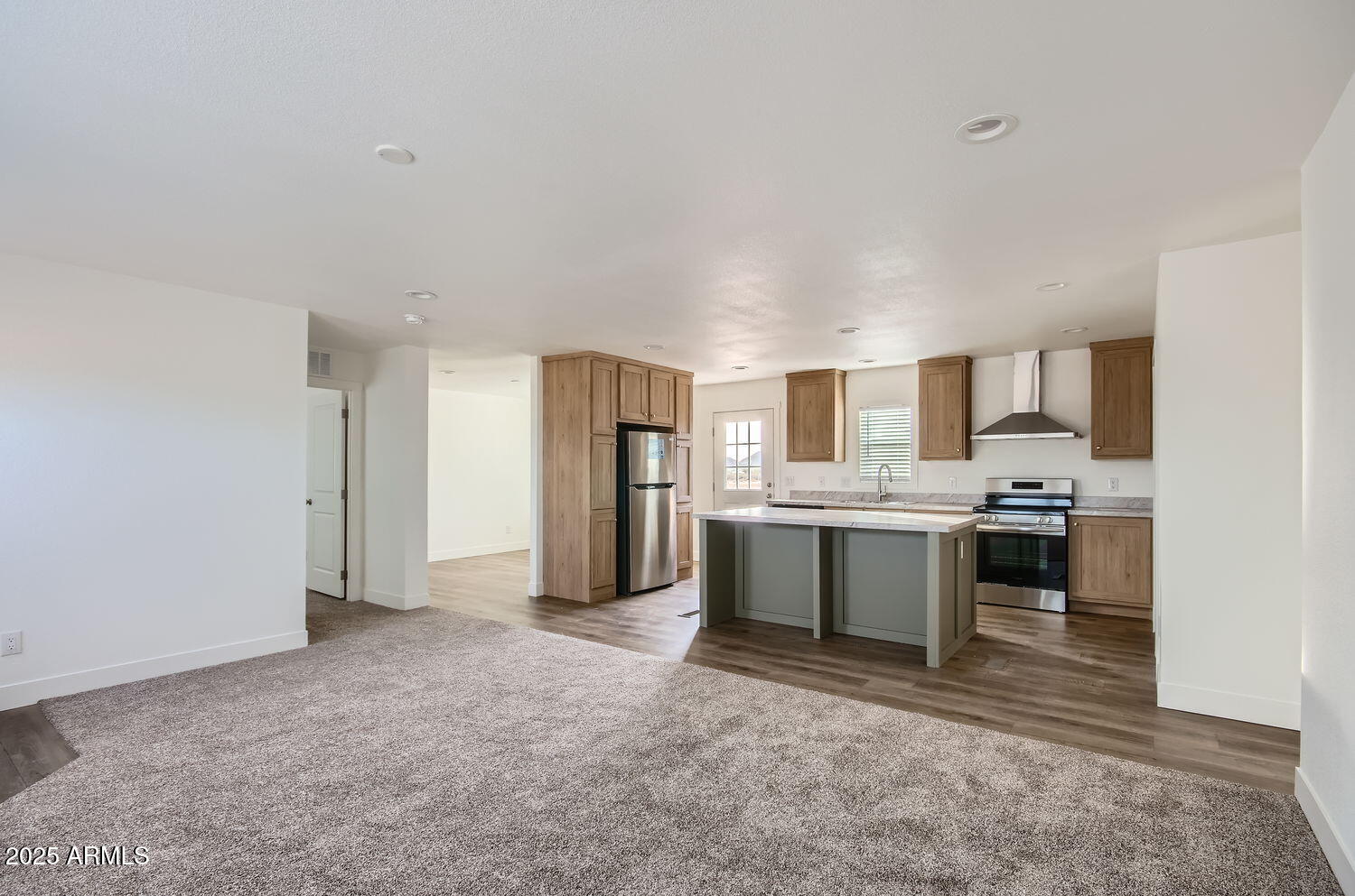 54362 West Thola Road Maricopa, AZ 85139 - Photo 8 of 9 a large kitchen with a refrigerator and white cabinets