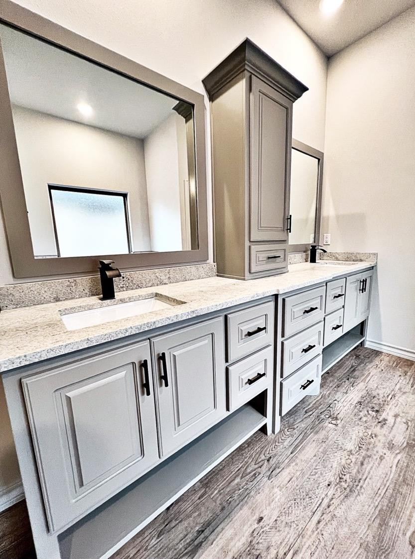 6920 17th Street Lubbock, TX 79416 - Photo 21 of 34 a bathroom with a granite countertop sink and a mirror