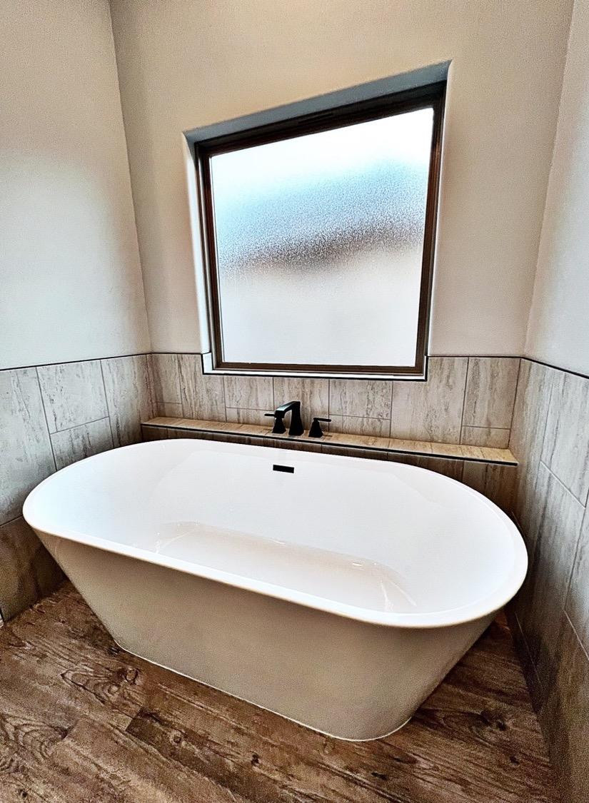 6920 17th Street Lubbock, TX 79416 - Photo 23 of 34 a bathroom with a sink and mirror