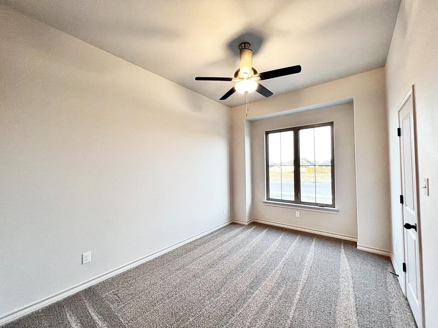 6920 17th Street Lubbock, TX 79416 - Photo 24 of 34 wooden floor in an empty room with a window