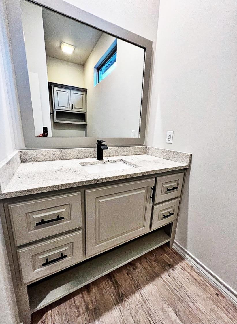6920 17th Street Lubbock, TX 79416 - Photo 26 of 34 a bathroom with a granite countertop sink and a mirror