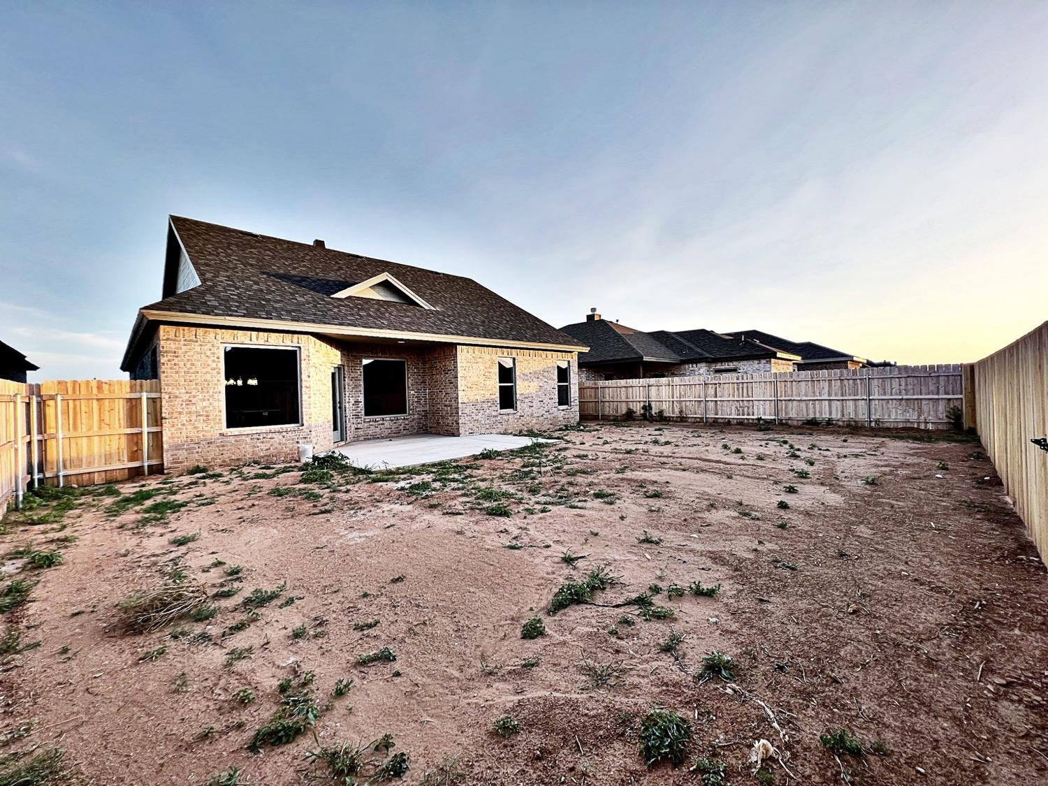 6920 17th Street Lubbock, TX 79416 - Photo 32 of 34 a front view of a house with a yard