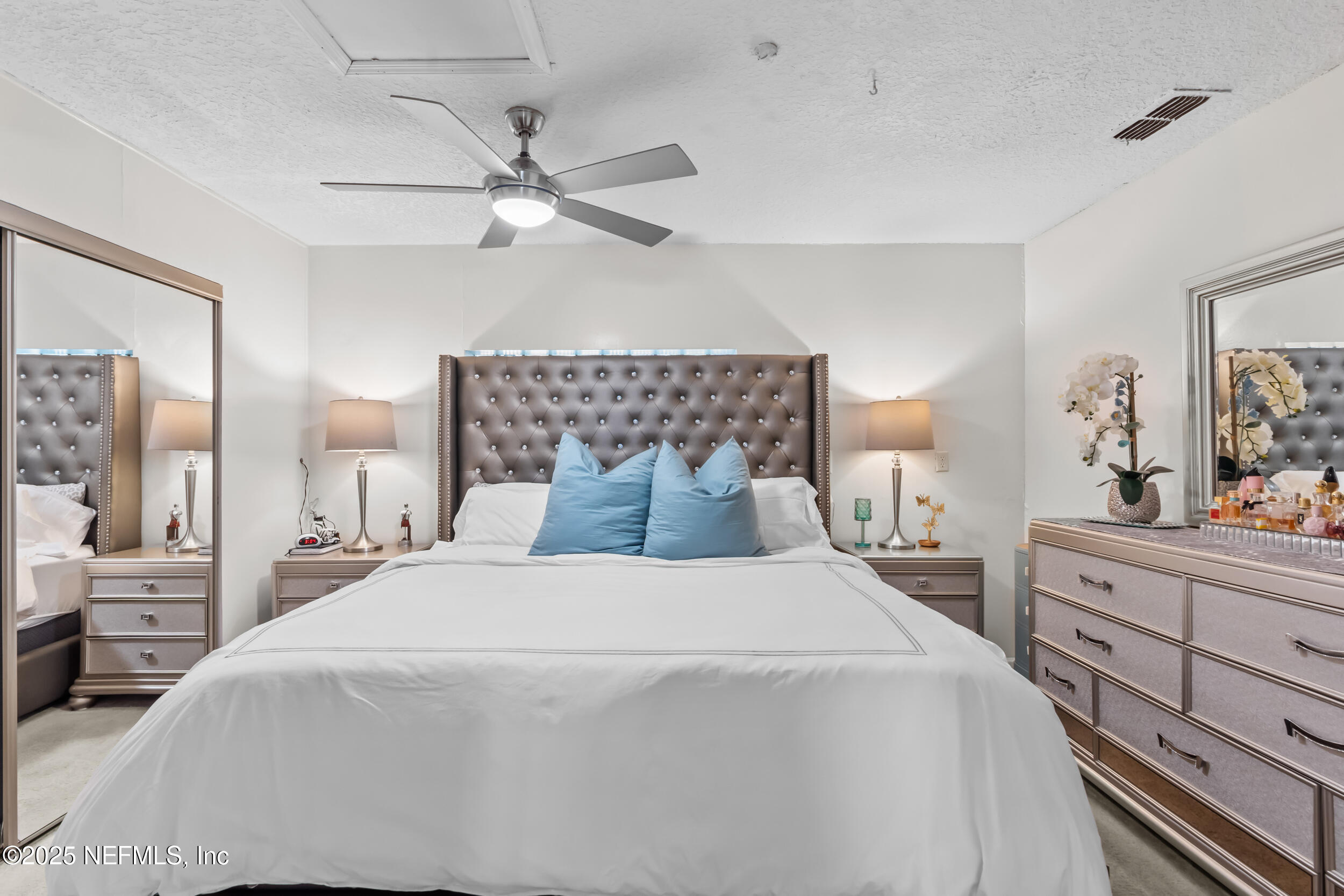 1887 Mayport Road Atlantic Beach, FL 32233 - Photo 21 of 50 a bedroom with a bed and a chandelier fan