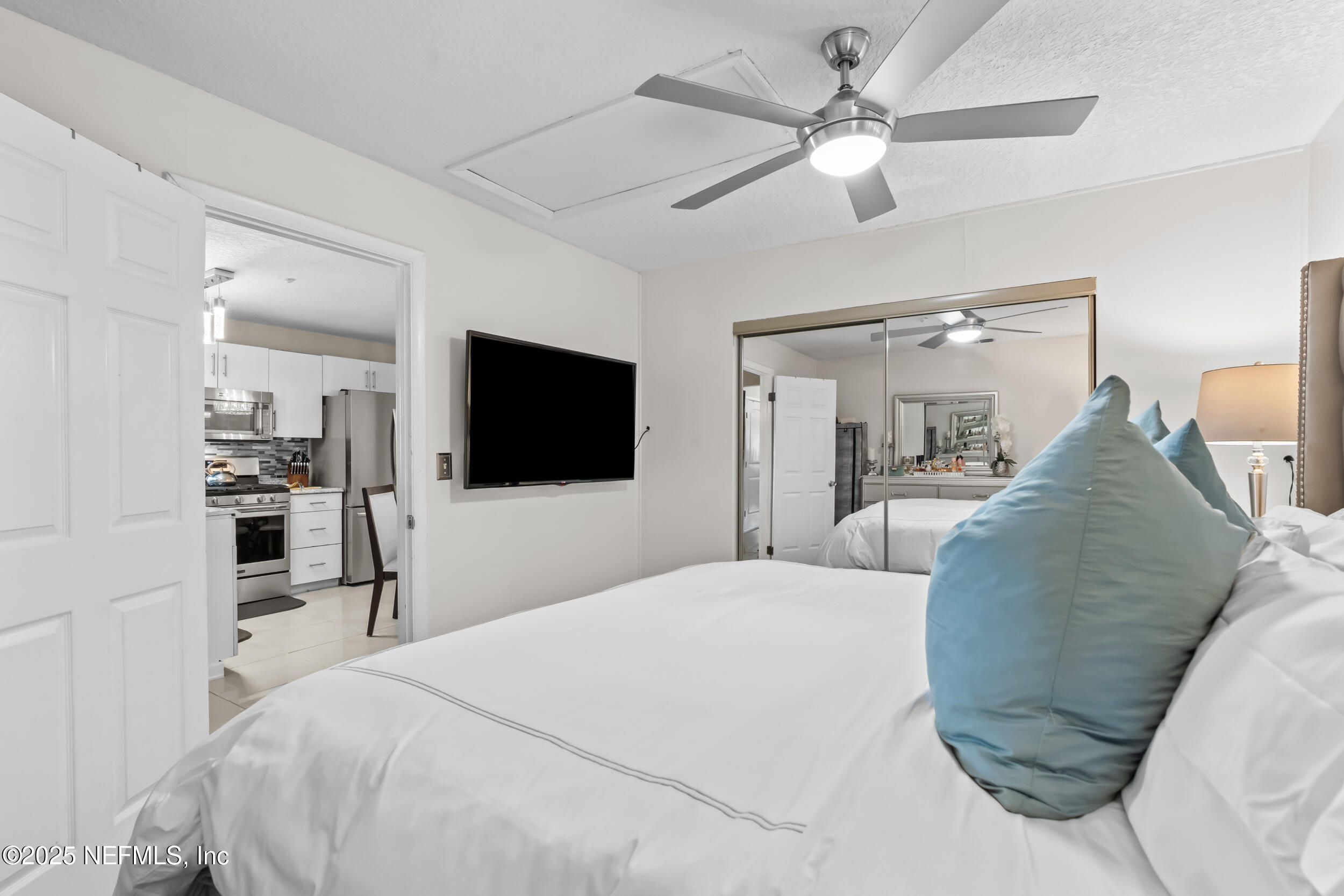 1887 Mayport Road Atlantic Beach, FL 32233 - Photo 22 of 50 a bedroom with a bed and a flat screen tv