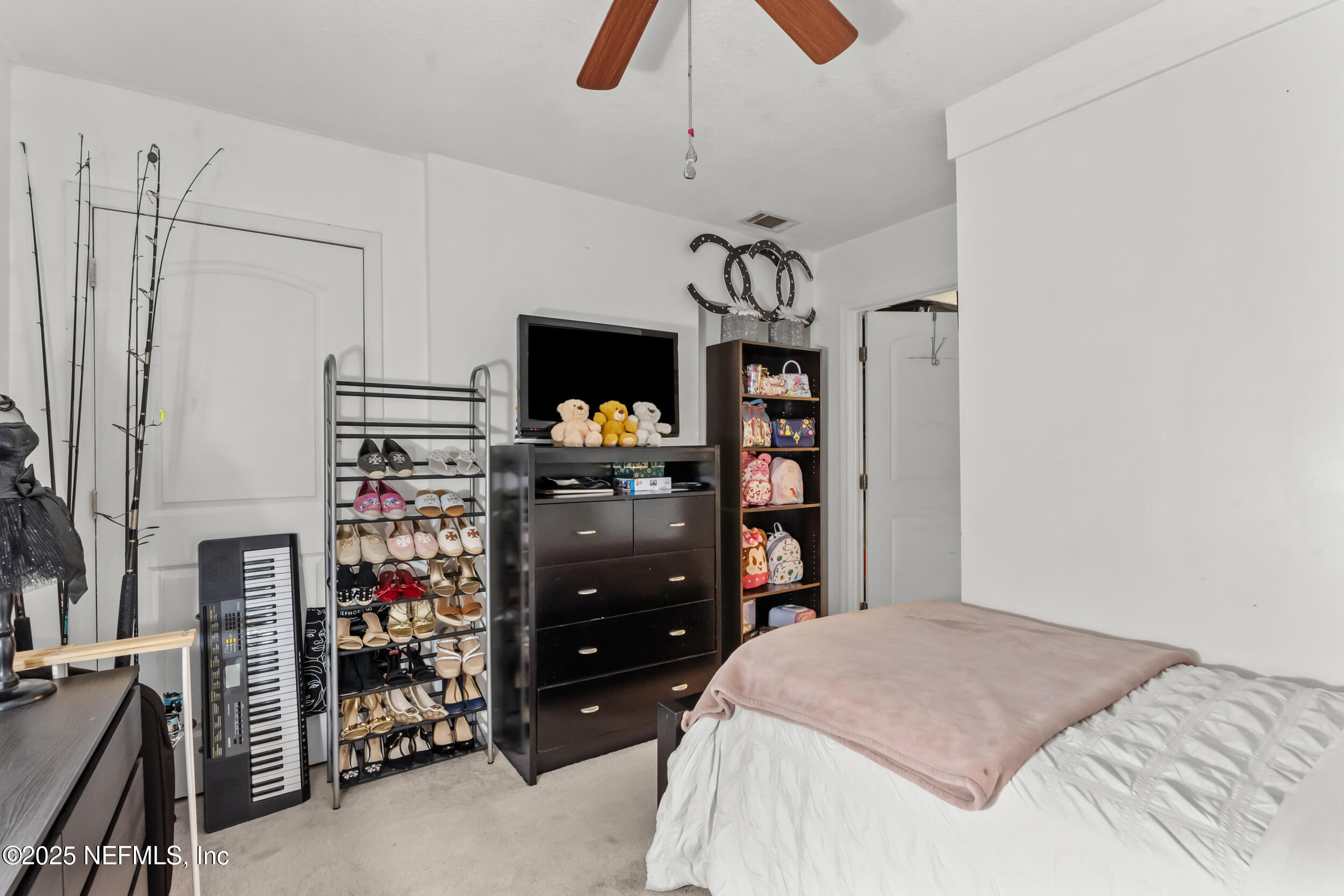 1887 Mayport Road Atlantic Beach, FL 32233 - Photo 27 of 50 a bedroom with a bed and a chandelier