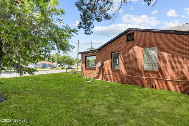 an aerial view of a house with swimming pool and outdoor space