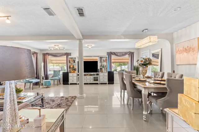 a dining room with furniture and window