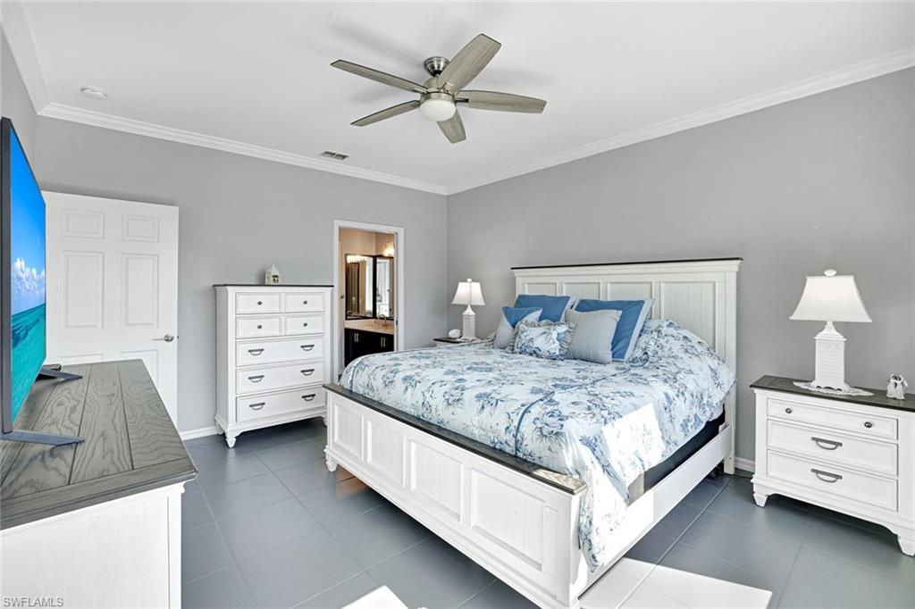 5967 Sand Wedge Lane, Unit 104 Naples, FL 34110 - Photo 11 of 41 a bedroom with a bed and a dresser