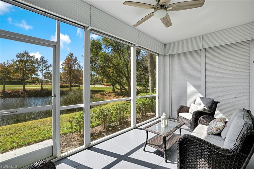 5967 Sand Wedge Lane, Unit 104 Naples, FL 34110 - Photo 18 of 41 a living room with furniture and a floor to ceiling window