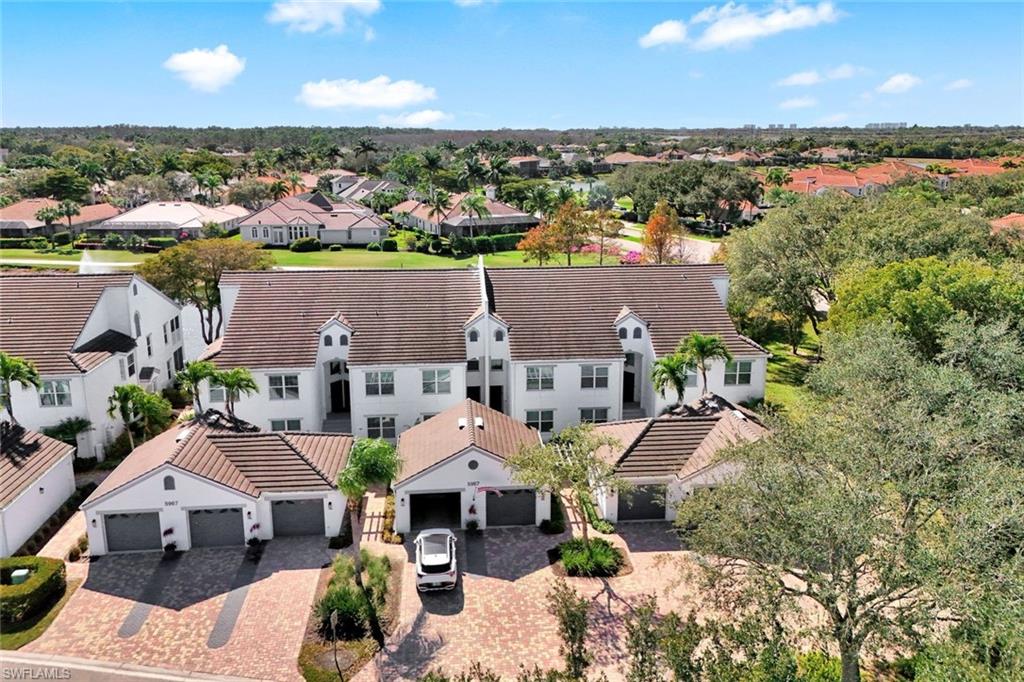 5967 Sand Wedge Lane, Unit 104 Naples, FL 34110 - Photo 20 of 41 an aerial view of a house with a garden