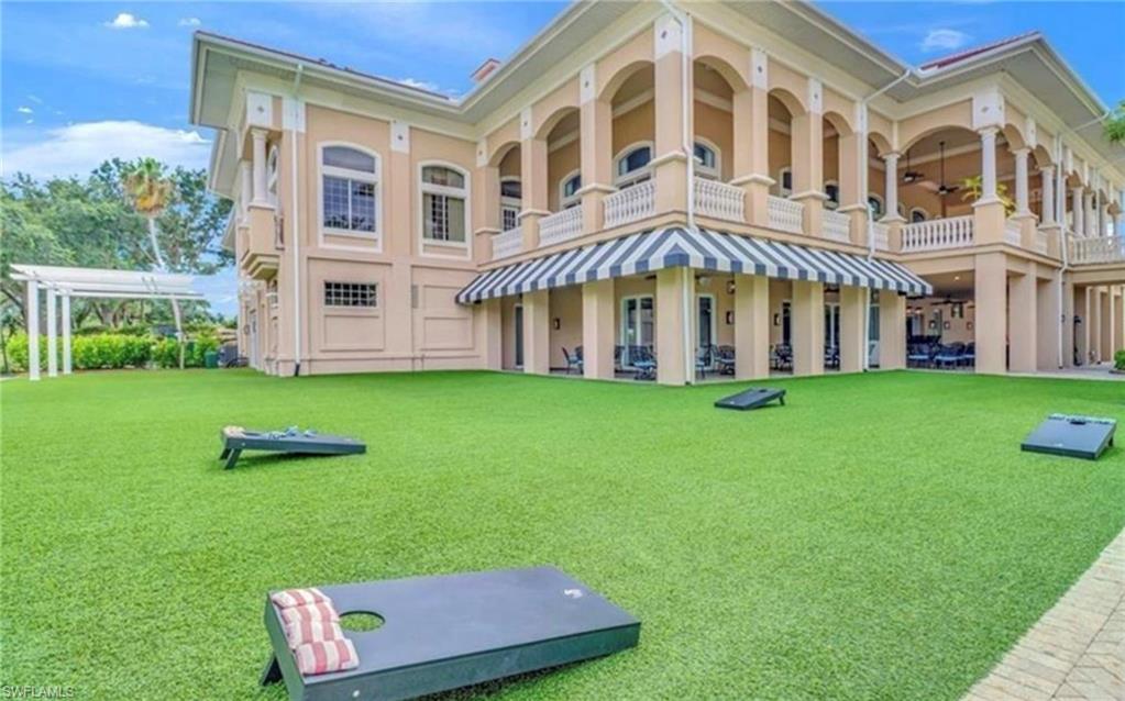 5967 Sand Wedge Lane, Unit 104 Naples, FL 34110 - Photo 30 of 41 a view of a building with a yard