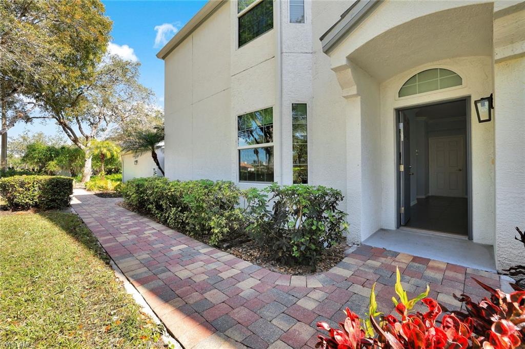 5967 Sand Wedge Lane, Unit 104 Naples, FL 34110 - Photo 3 of 41 a view of a bunch of flowers in front of main door