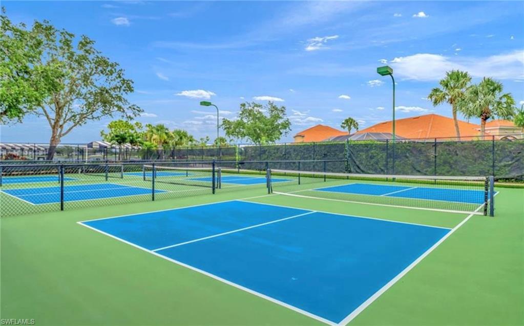 5967 Sand Wedge Lane, Unit 104 Naples, FL 34110 - Photo 32 of 41 a view of an outdoor space and basketball court