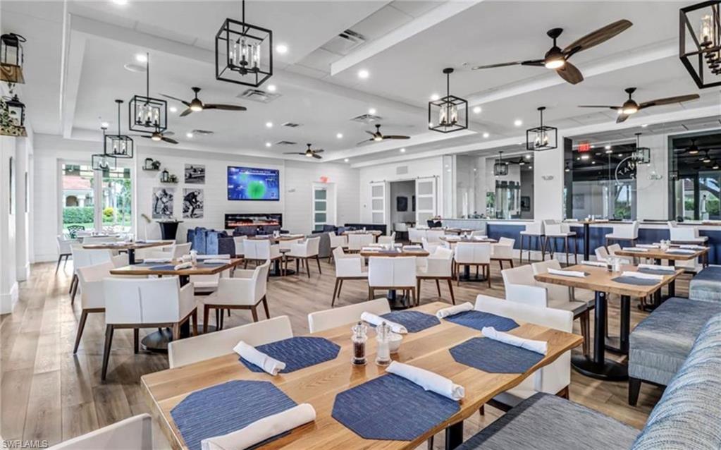 5967 Sand Wedge Lane, Unit 104 Naples, FL 34110 - Photo 39 of 41 a living room with lots of furniture and view of kitchen