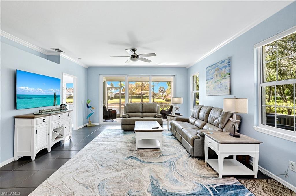 5967 Sand Wedge Lane, Unit 104 Naples, FL 34110 - Photo 4 of 41 a living room with furniture and a flat screen tv