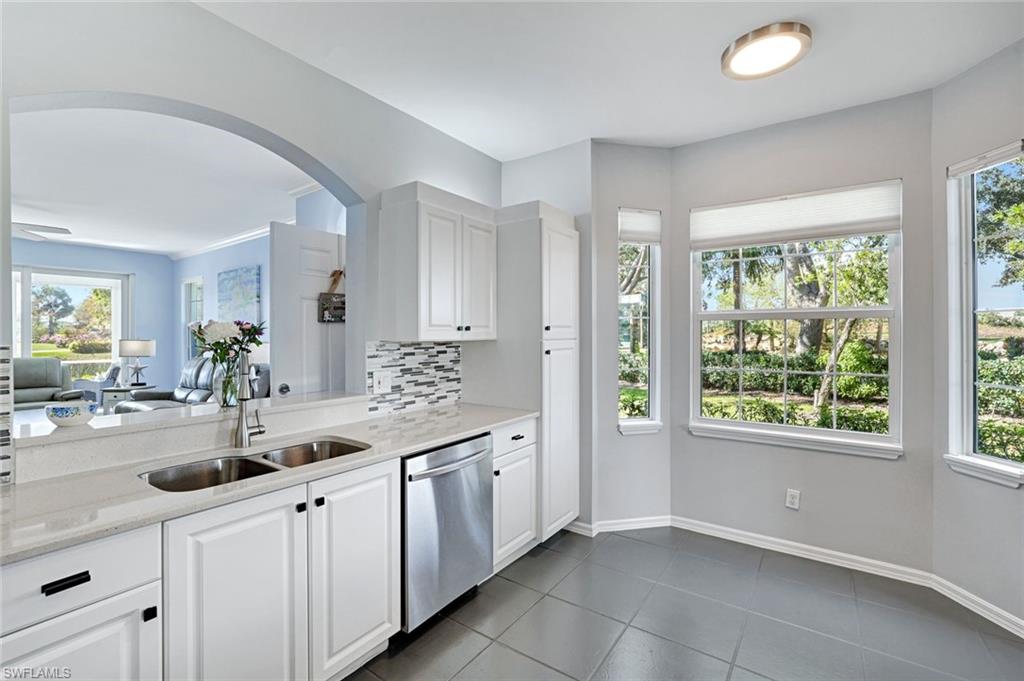 5967 Sand Wedge Lane, Unit 104 Naples, FL 34110 - Photo 8 of 41 a kitchen with sink and window