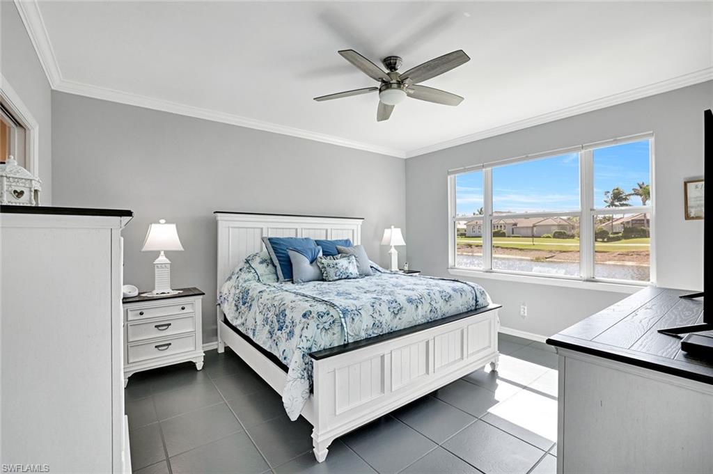 5967 Sand Wedge Lane, Unit 104 Naples, FL 34110 - Photo 10 of 41 a bedroom with a large bed and a large window