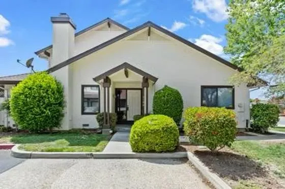 a front view of a house with garden