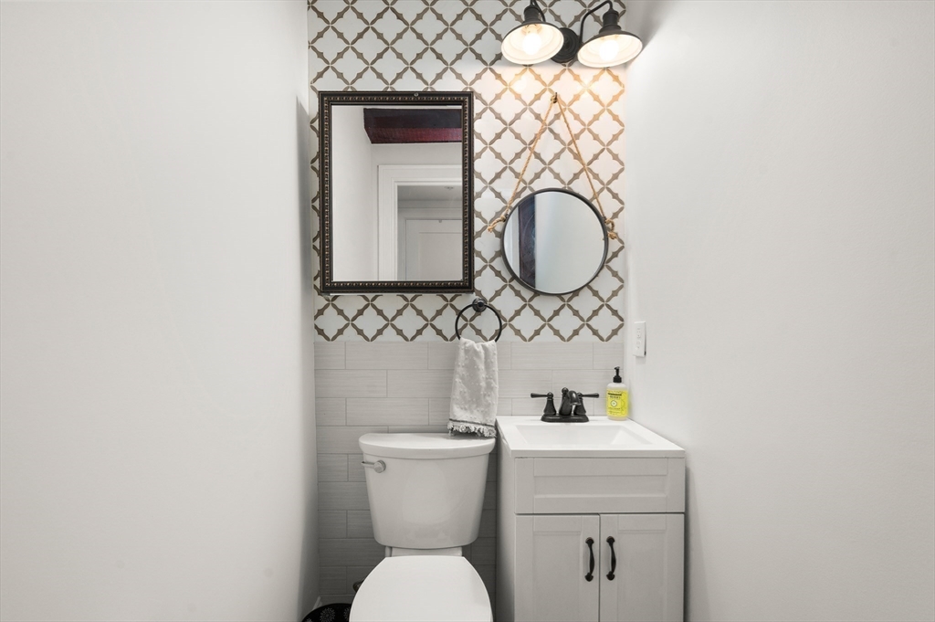 12 Mall Street, Unit C Salem, MA 01970 - Photo 11 of 31 a bathroom with a toilet sink vanity and mirror