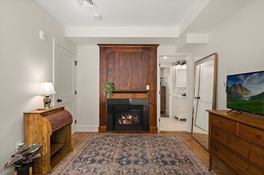 12 Mall Street, Unit C Salem, MA 01970 - Photo 17 of 31 a living room with furniture a flat screen tv and a fireplace