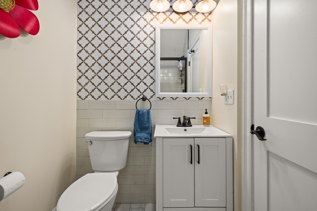 12 Mall Street, Unit C Salem, MA 01970 - Photo 23 of 31 a bathroom with a toilet sink and mirror