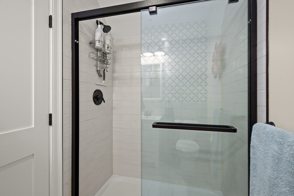 12 Mall Street, Unit C Salem, MA 01970 - Photo 27 of 31 a bathroom with a glass shower door