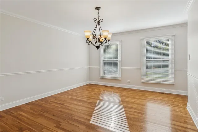 a view of a livingroom with wooden floor and a window