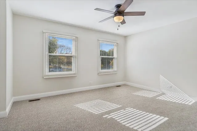 a view of room with a ceiling fan and window