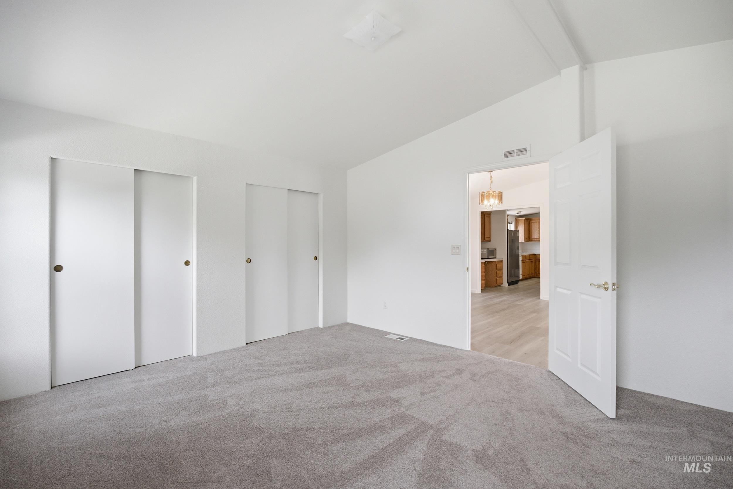 7422 Track Road Nampa, ID 83686 - Photo 21 of 50 Utility room featuring a utility sink, wood cabinetry, light wood-finish flooring, white countertops, and white tile backsplash