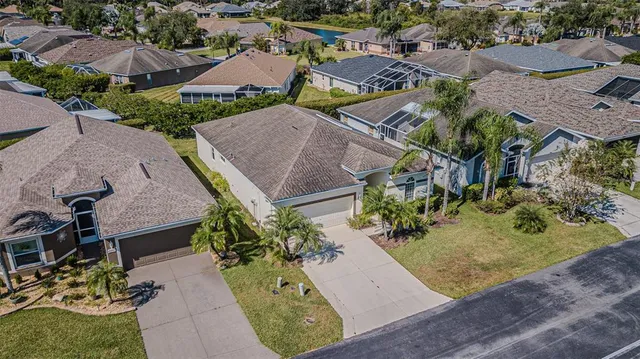 an aerial view of a house with a yard and plants