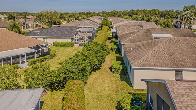 an aerial view of a house with a yard