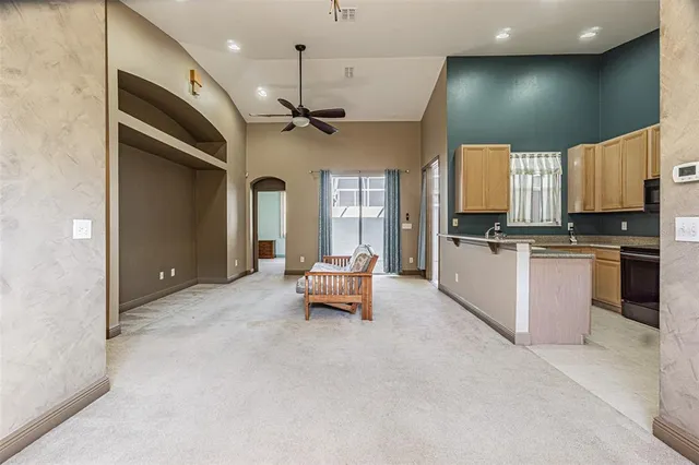 a kitchen with stainless steel appliances kitchen island granite countertop a refrigerator and a stove top oven