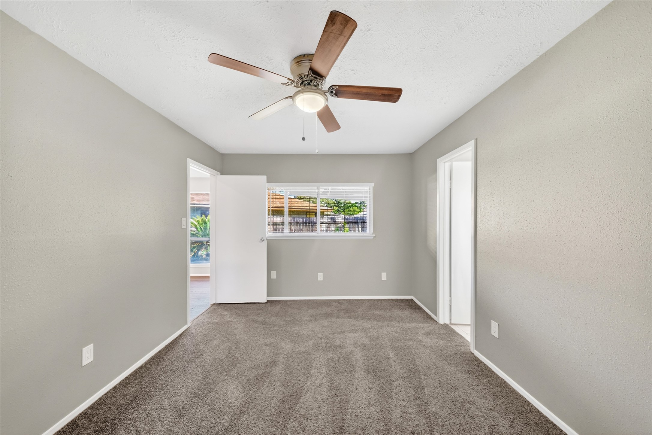 3119 Oak Rock Spring, TX 77373 - Photo 14 of 25 an empty room with windows and fan
