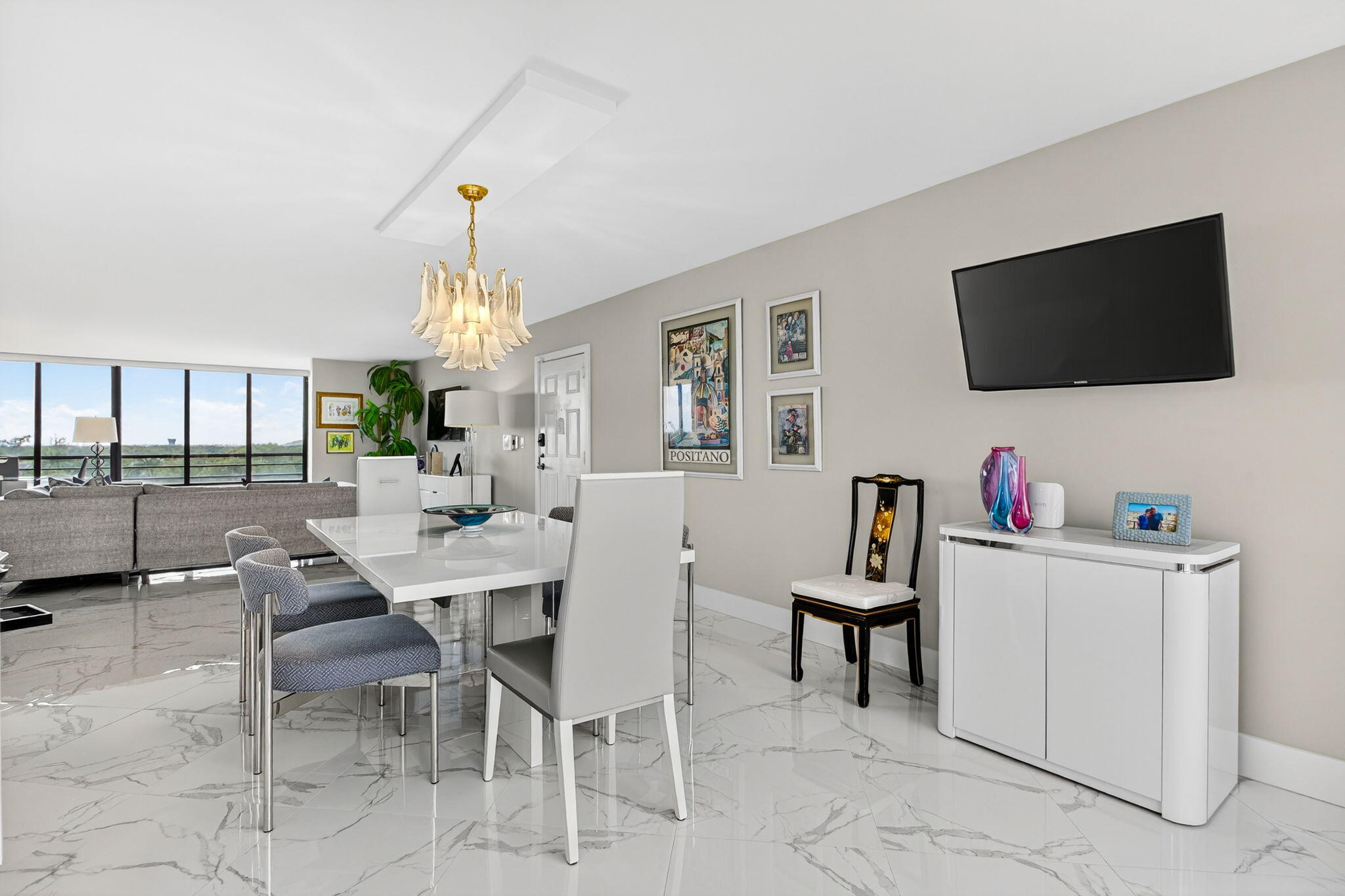 7186 Promenade Drive, Unit 701 Boca Raton, FL 33433 - Photo 12 of 39 a view of a livingroom with furniture and a flat screen tv