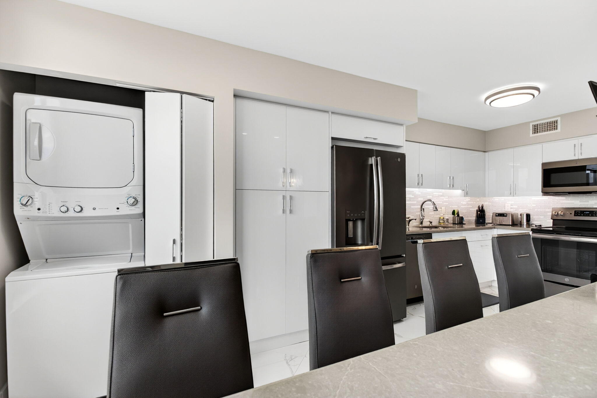 7186 Promenade Drive, Unit 701 Boca Raton, FL 33433 - Photo 16 of 39 a kitchen with stainless steel appliances a refrigerator stove and microwave