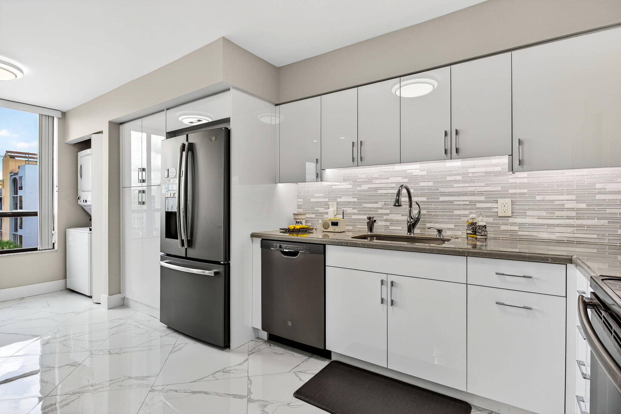 7186 Promenade Drive, Unit 701 Boca Raton, FL 33433 - Photo 17 of 39 a kitchen with granite countertop cabinets and stainless steel appliances