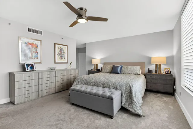 a spacious bedroom with a bed and a window