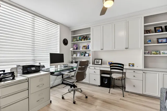a view of a workspace with furniture and a window